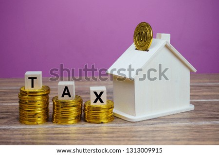 Text enabled conceptual photo on financial matter. Tax concerns on property sales. Selectively focused and isolated on pink background.