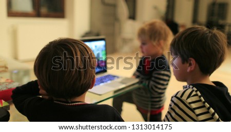 Child hypnotizd by screen, young boy watching cartoon content online starring at screen