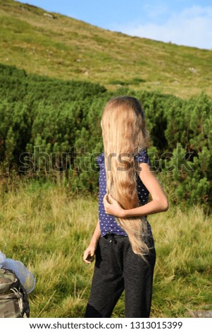 Blonde girl with long flowing hair in the mountains, Carpathians