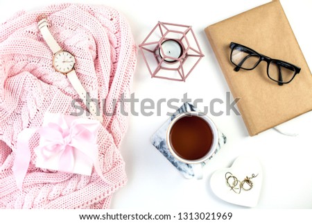 Spring decor. Women's clothing. Watch, gift box with a pink ribbon, jewelry, a candle, a mug of tea on a white background. Spring.
