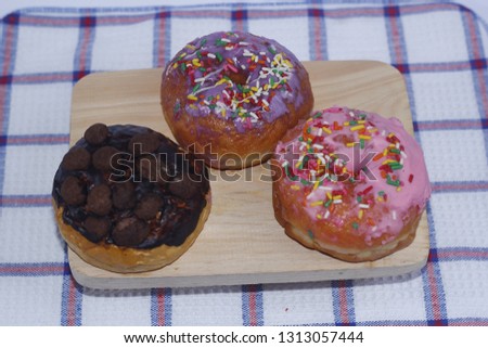 Donuts on woode table. Top view with copy space and sprinkles donuts