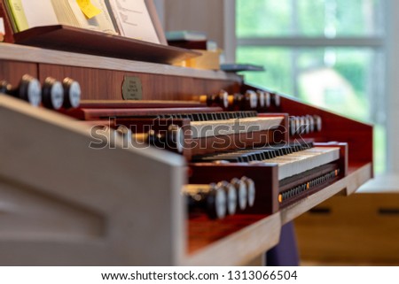 Close up photo of a keyboard of organs in church. Shallow depth of field macro.