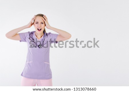 Woman doctor blonde young light gray background studio day beautiful one stethoscope pink purple lilac clothes tired of hard work. dissatisfied  boss not sleep. Copy space right.