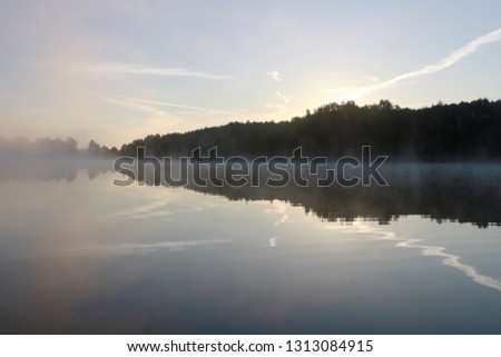 Landscape of a foggy lake in the morning as a natural background.