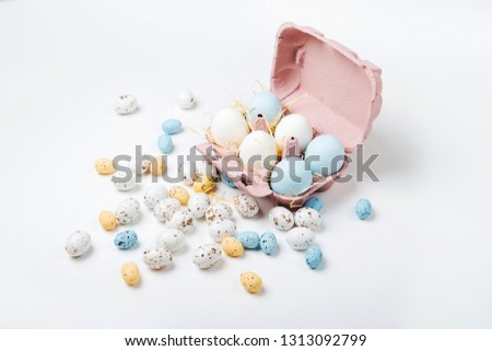 Natural Colored  Eggs in egg box with Easter candies. Compositions in pastel colors. Easter consept.  