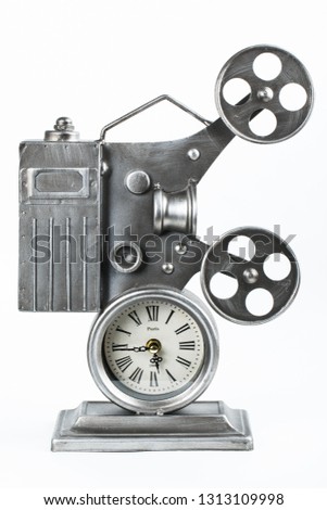 Clock in the form of an old movie camera on a white background