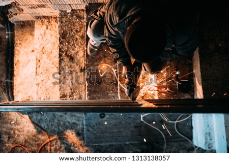 construction industry details - caucasian male, metalworker using disc grinder for cutting metal