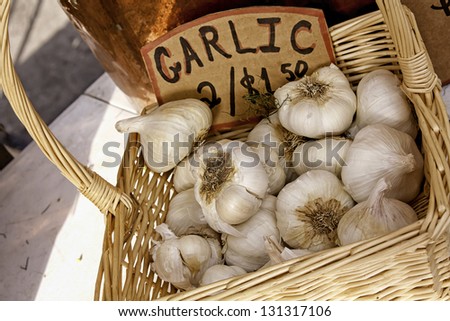 Basket of fresh garlic with sign at local farmers market