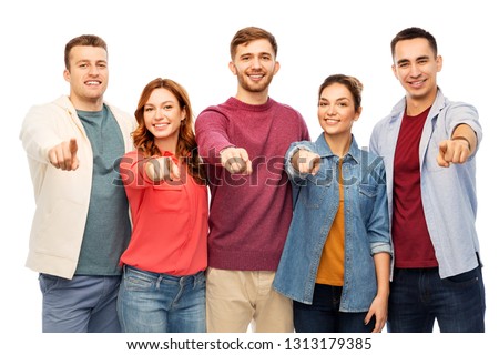 friendship and people concept - group of smiling friends pointing at you over white background