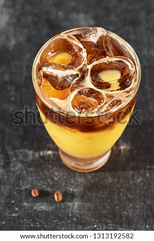 Orange and coffee cocktail with space for your text. Cocktail on a wooden background. Picture taken outside on a sunny day. top view