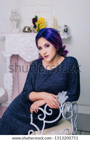 The girl with purple hair in the bright interior.