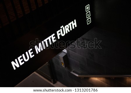 Entrance to Metro Station in German Town Furth in Night. Shining Inscription Neue Mitte Furth, in English New Centre of Furth.