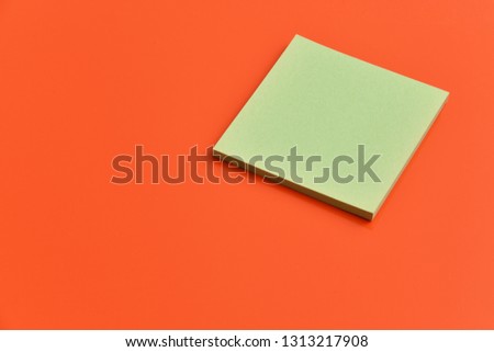 Green paper on orange background