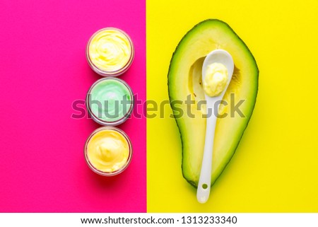 Avocado cream in pot with fruit. Cosmetics from natural ingredients natural concept.
