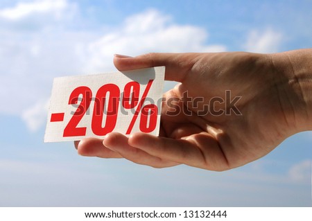 female hand holding sale card against sky, photo does not infringe any copyright