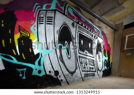 a graffii art work of a boom box ghettoblaster on a wall 