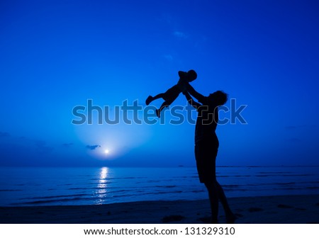 silhouette of happy man jumping at the beach.