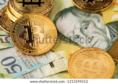 Bitcoin Cryptocurrency on Venezuela money Bolivar banknotes close up image. Bitcoin virtual money on Venezuela money Bolivar banknotes.