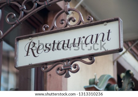 closeup of vintage restaurant sign on building facade 