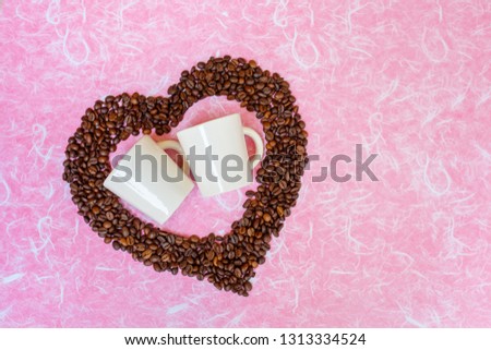 Valentine's Day concept. Coffee been and two white cups on white pink background. Top view with copy space.