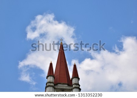 Church Roof with a cross. Church building roof with holy cross with blue sky and white cloud background at Thailand.