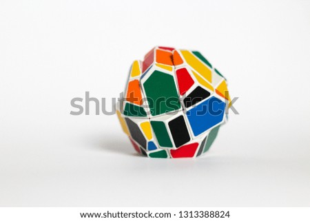 Multi-colored unusual puzzle, strange shape cube, on a white background