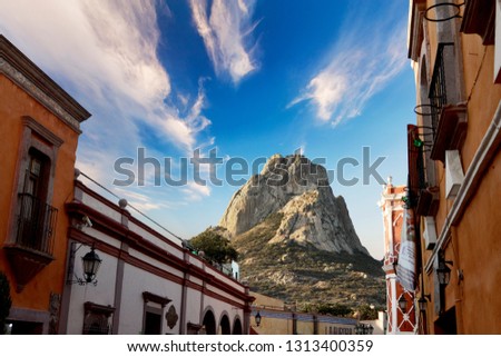 Peña de Bernal with a beautiful blue sky and white clouds. Royalty-Free Stock Photo #1313400359