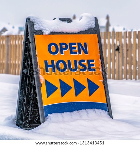 Open House sign in front of a real estate for sale