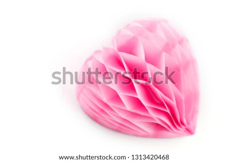 A lush pink paper heart on a white background. Paper heart isolated on white