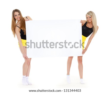 Two young pretty women with empty board for the text on a white background.