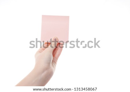 paper sticker in women's hands on white background
