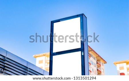 signboard mockup and template blank advertising or light box with copy space for your text message or media and content, signage with shadow in dark frame with city wall background display exterior.