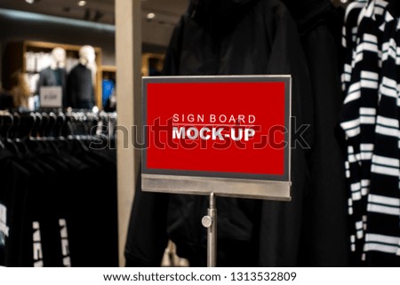 Mock up blank desktop label on steel pole with clipping path, perspective red screen the empty space for insert text or advertising promotion in shop clothing
