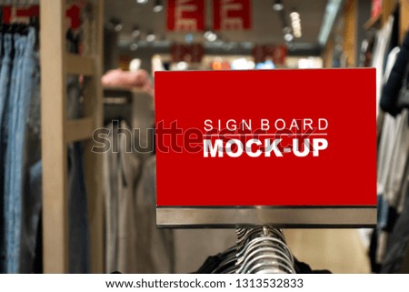 Mock up blank desktop label on hangers with clipping path, perspective red screen the empty space for insert text or advertising promotion in shop clothing