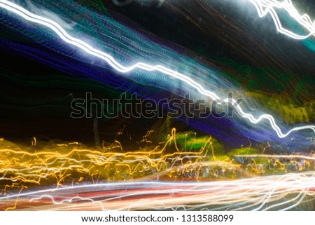 abstract image containing light-drawn stripes on a dark background
