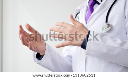 Medical doctor explaining something for patient by making hands gestures.