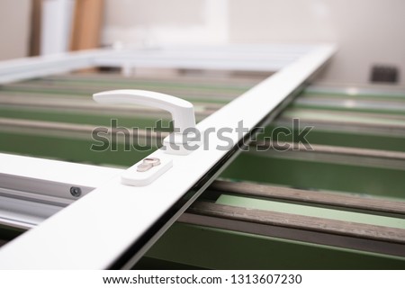 detail of lock and handle during the manufacture of a aluminium door Royalty-Free Stock Photo #1313607230