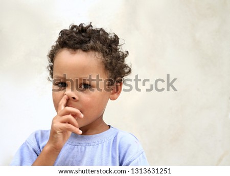 Little boy picking his nose and having fun stock photo