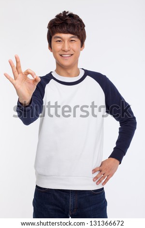 Young asian man showing okay sign isolated on white background.