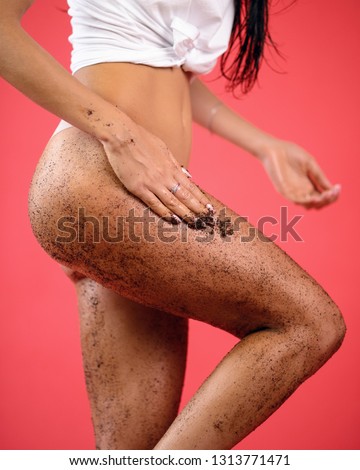 Anti-cellulite wrapping procedure with scrub, close up plan of buttocks and legs