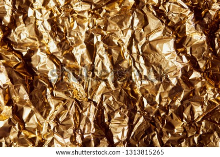 creased golden foil sheet with twinkles