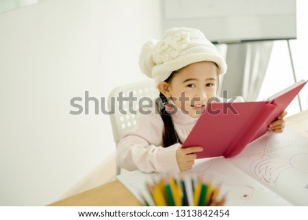 Asian cute little child girl drawing at home
