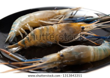 Fresh Shrimp in black dish isolated on white background