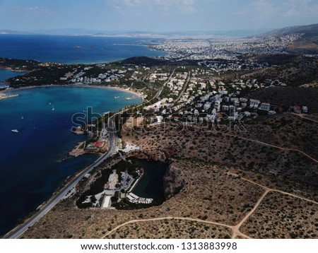 Aerial drone, bird's eye photo from iconic lake Vouliagmeni famous for healing abilities, Athens riviera, Attica, Greece