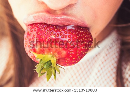 Food, healthy diet, dieting. Strawberry in mouth with rosy lips, makeup. Beauty, lipstick, lip gloss, make up. Summer, fruit berry harvest season Nutrition health vitamin