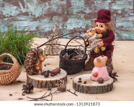 Postcard with small toys. The forester met in the forest with a hedgehog and a small pink pig who had harvested nuts.