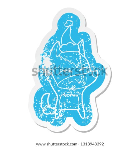 quirky cartoon distressed sticker of a wolf whistling wearing santa hat