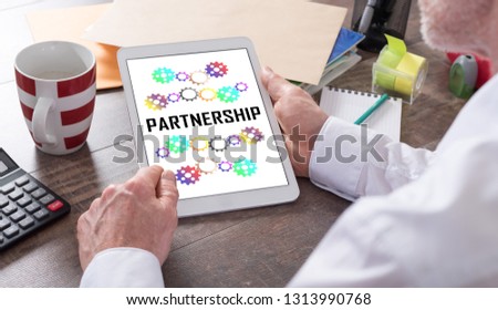 Partnership concept shown on a tablet held by a man