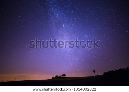 Shooting Stars Crossing in Milky Way and Starry Sky before Dawn Royalty-Free Stock Photo #1314002822