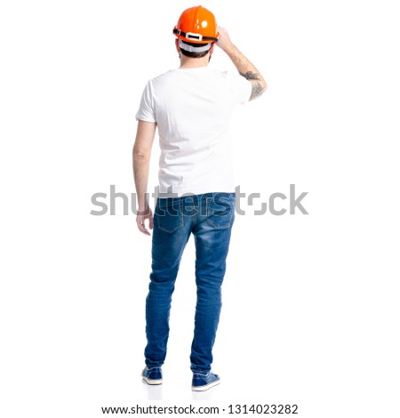 Man with building helmet in hand on white background isolation, back view